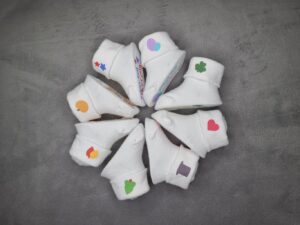 Baby's 1st Holidays 8 sock set placed in a star shape. Cuffs of socks have graphics to coincide with each of the 8 holidays.