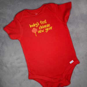 "Baby's First Chinese New Year" red bodysuit with red lantern graphic on grey background