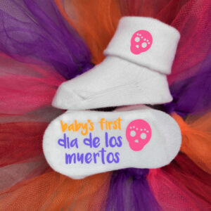 Baby's First Dia de Los Muertos socks with skull graphic displayed against tutu